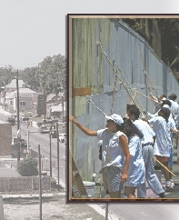 photograph of a group of people painting a wall