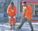 photograph of two men repairing a road