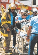 photograph of emergency medical service workers helping a person on a stretcher