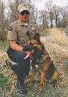 photograph of a police officer and rescue dog