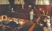 photograph of a courtroom showing lawyers judge, and jury members