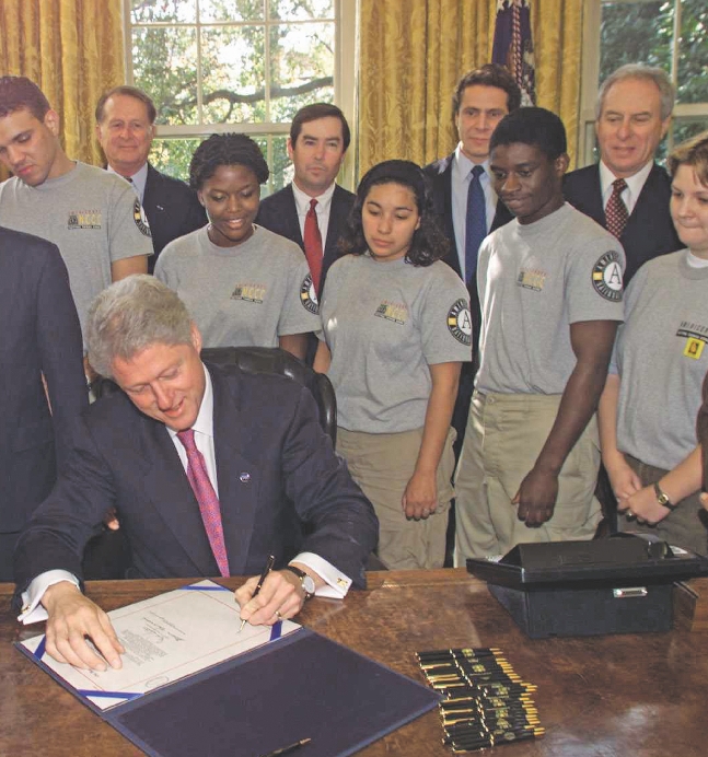 President Bill Clinton signs a bill to make it a law.