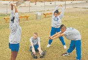 photograph of a group of students exercising in a field