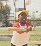 photograph of a girl swinging a baseball bat