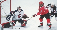 photograph of hockey players on a hockey ice rink