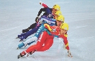 photograph of a group of speed skaters on an ice rink