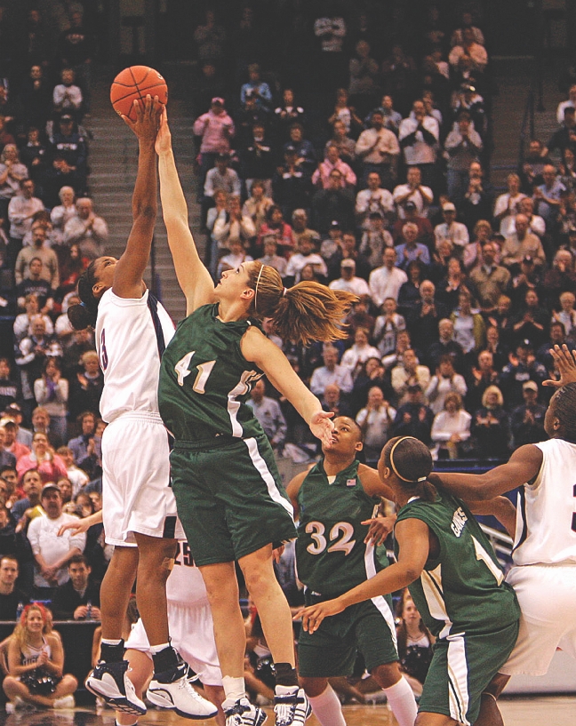 photograph of female basketball players on a basketball court