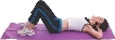 photograph of a woman lying on her back on an exercise mat