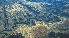 A photograph of a range of rocks that are divided by deep cuts running across the range