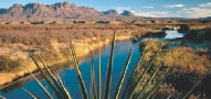 scenic photograph of mountains, land, and a river