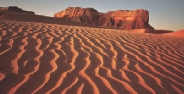 scenic photograph of a desert with mountains in the far background