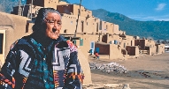 photograph of a Native American person with town in background