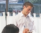 photograph of a male waiter writing down a food order