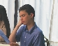 photograph of a teenage boy seated at a restaurant table