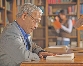 photograph of a man reading a book