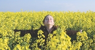 photograph of a girl in a field of flowers