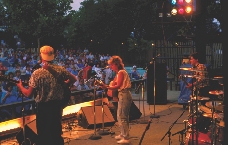 A band plays a song at night.