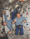 photograph of a male astronaut inside the space shuttle