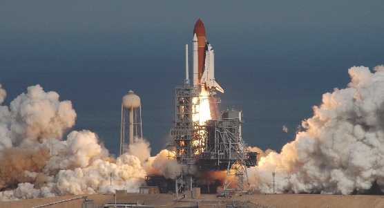 The space shuttle Atlantis blasts off into orbit.