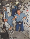 photograph of two astronauts inside the space shuttle