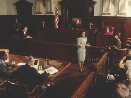 photograph of a courtroom with lawyers, judge, and jury members