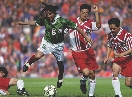 photograph of male soccer players playing on a field