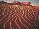 photograph of desert sand and mountains in the distance