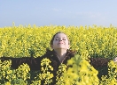 photograph of a woman standing in a field of flowers