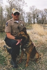 photograph of a police officer and a search and rescue dog