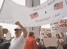 photograph of a group of people at a protest rally