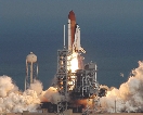 photograph of the space shuttle lifting off its launch pad