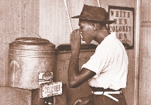 photograph of a man drinking from a water cooler