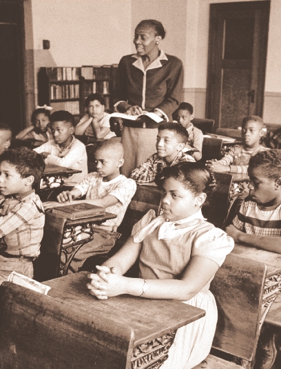 photograph of a classroom with black students and female teacher