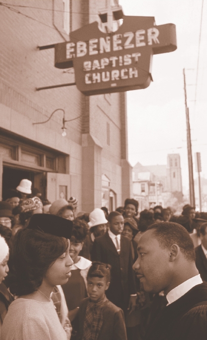 photograph of Martin and people standing in front of the church building