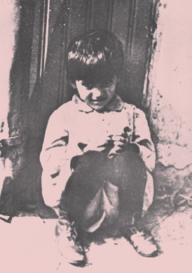 photograph of a child sitting alone