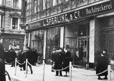 photograph of a Jewish store front and street with people on it