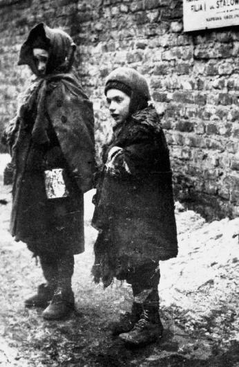 photograph of two homeless children dressed in rags