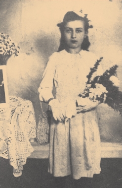 photograph of a young girl holding a bouquet of flowers