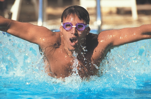 illustration of a young man swimming in a pool, doing the breast stroke