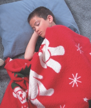 photograph of a boy in bed sleeping