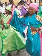 Photograph of a Haitian woman in traditional dress dancing.