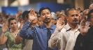 Photograph of adults, each one holding up their right hand