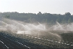 Photograph of a field being watered with irrigation pipelines