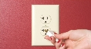 Photograph of a hand inserting a plug into an electrical outlet