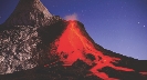 Photograph of a river of red-hot lava flowing down the side of a volcano