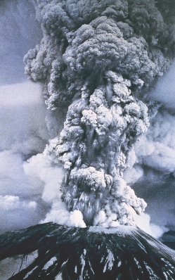 Photograph of a volcano erupting and sending ash high up into the air