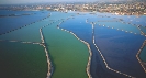 Photograph of several walls built (levees) in a river