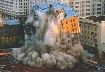 Photograph of a building in the process of collapsing