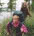 Photograph of a man running in terror from a bear that is chasing him