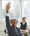 Photograph of a student in a classroom raising her hand